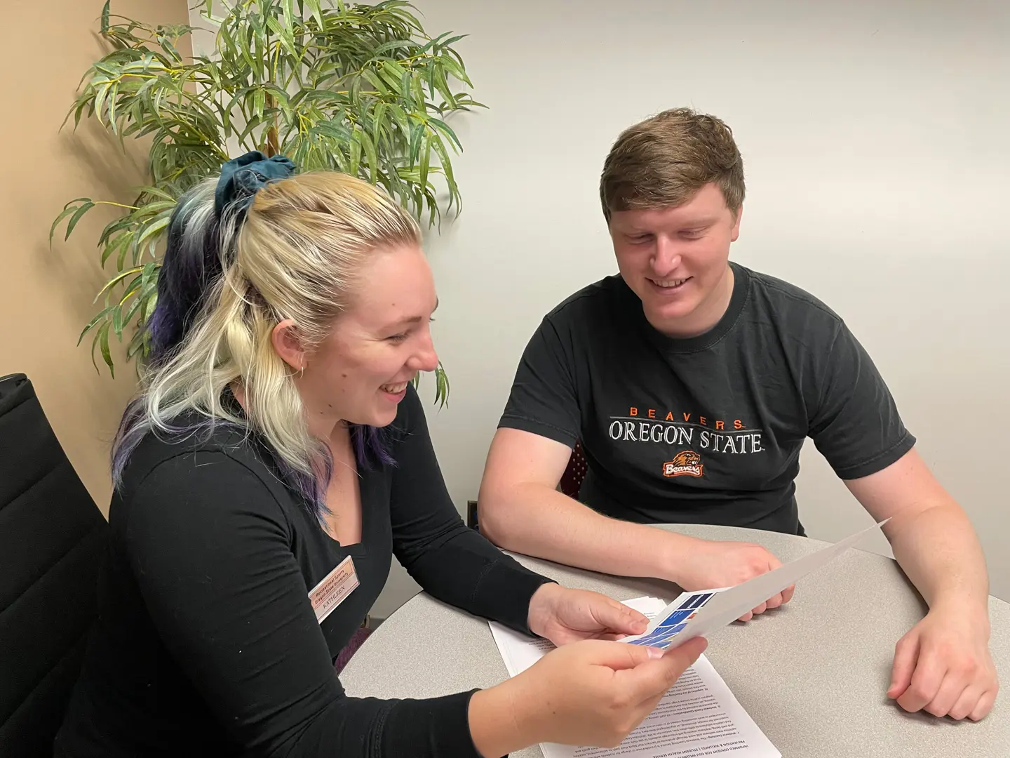 Wellness Coaching Session in progress, Wellness Coach reviews materials with client. 
