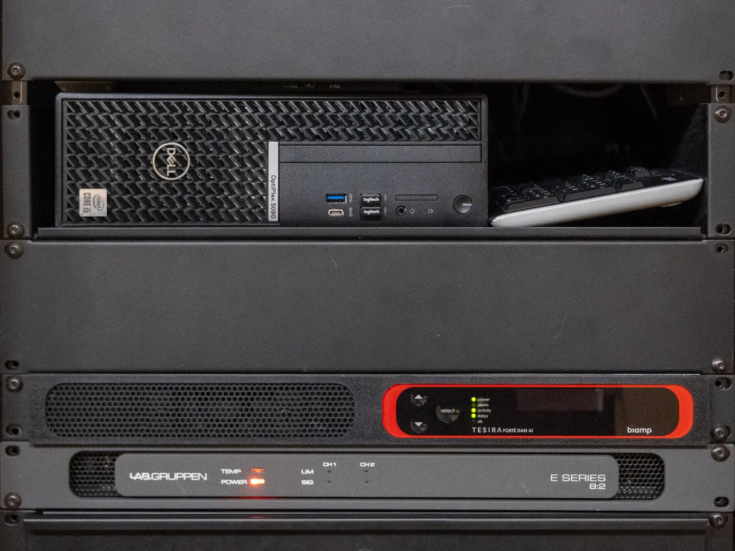 A computer rack with a PC and keyboard up top and other equipment down below.